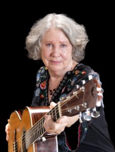 Photo of Mary Flower with her guitar